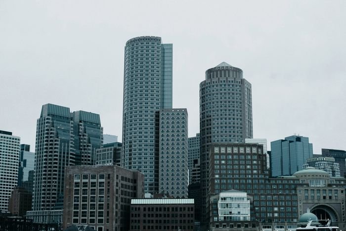 The Boston financial district skyline on an overcast day, seen from the harbor